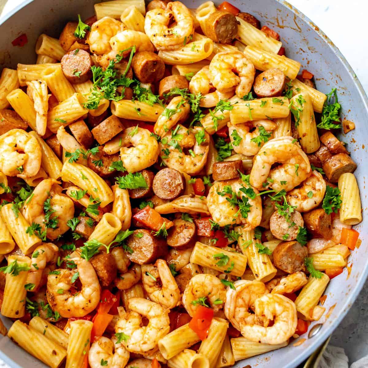 Cajun Shrimp And Sausage Pasta in a grey pan.