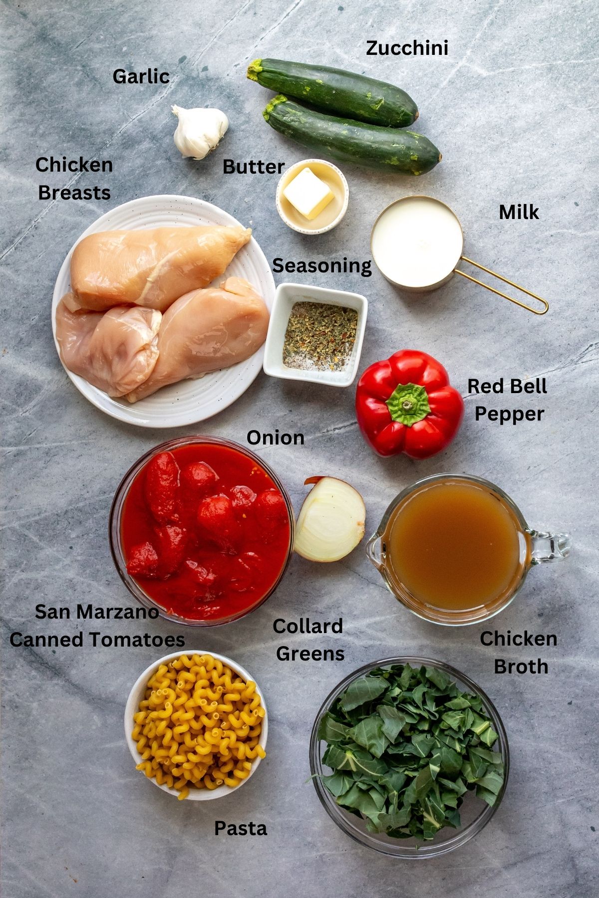Ingredients needed in small bowls, plates and measuring cups on a grey counter. 