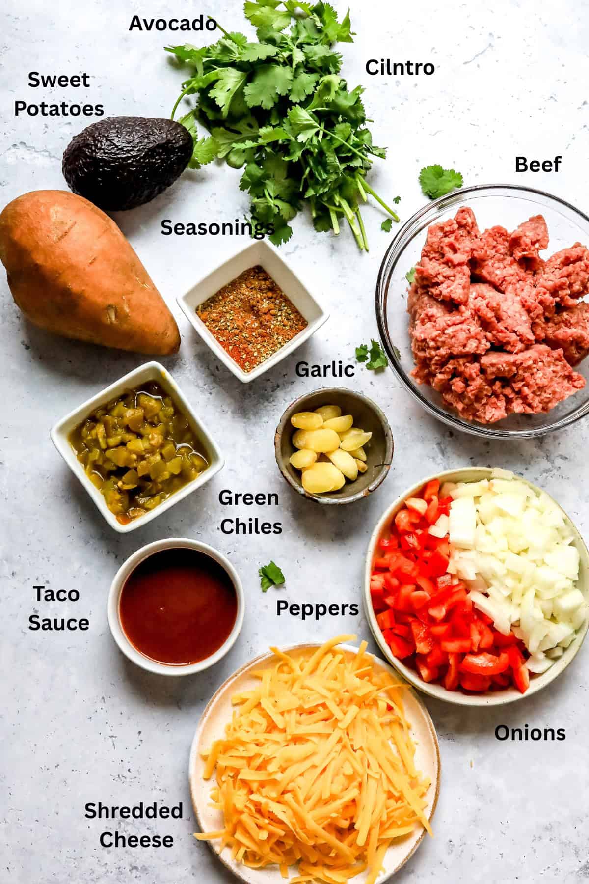Ingredients laid out on a grey counter in small bowls and plates.