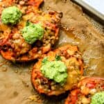 Stuffed Sweet Potatoes on a baking sheet with melted cheese.