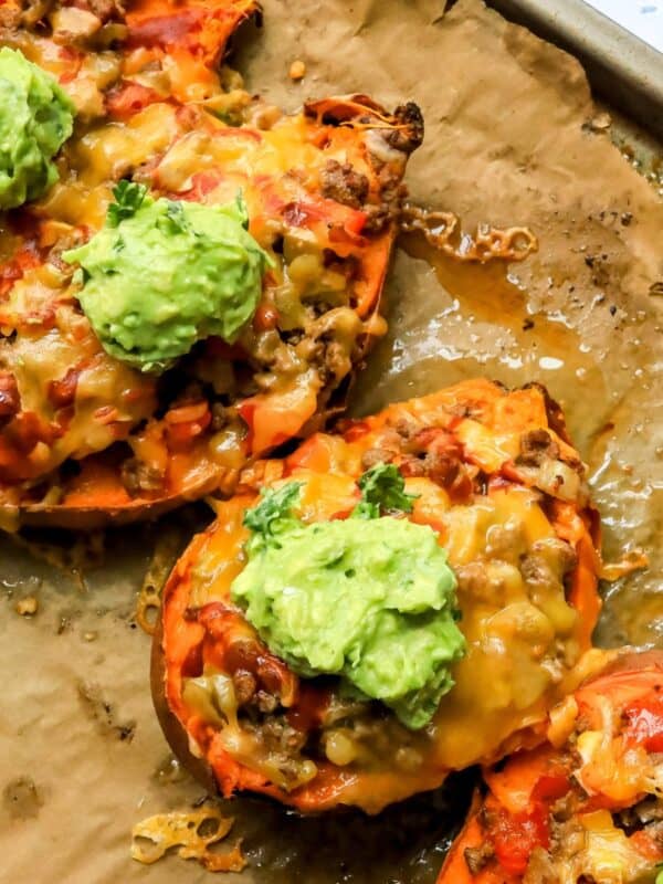 Stuffed Sweet Potatoes on a baking sheet with melted cheese.