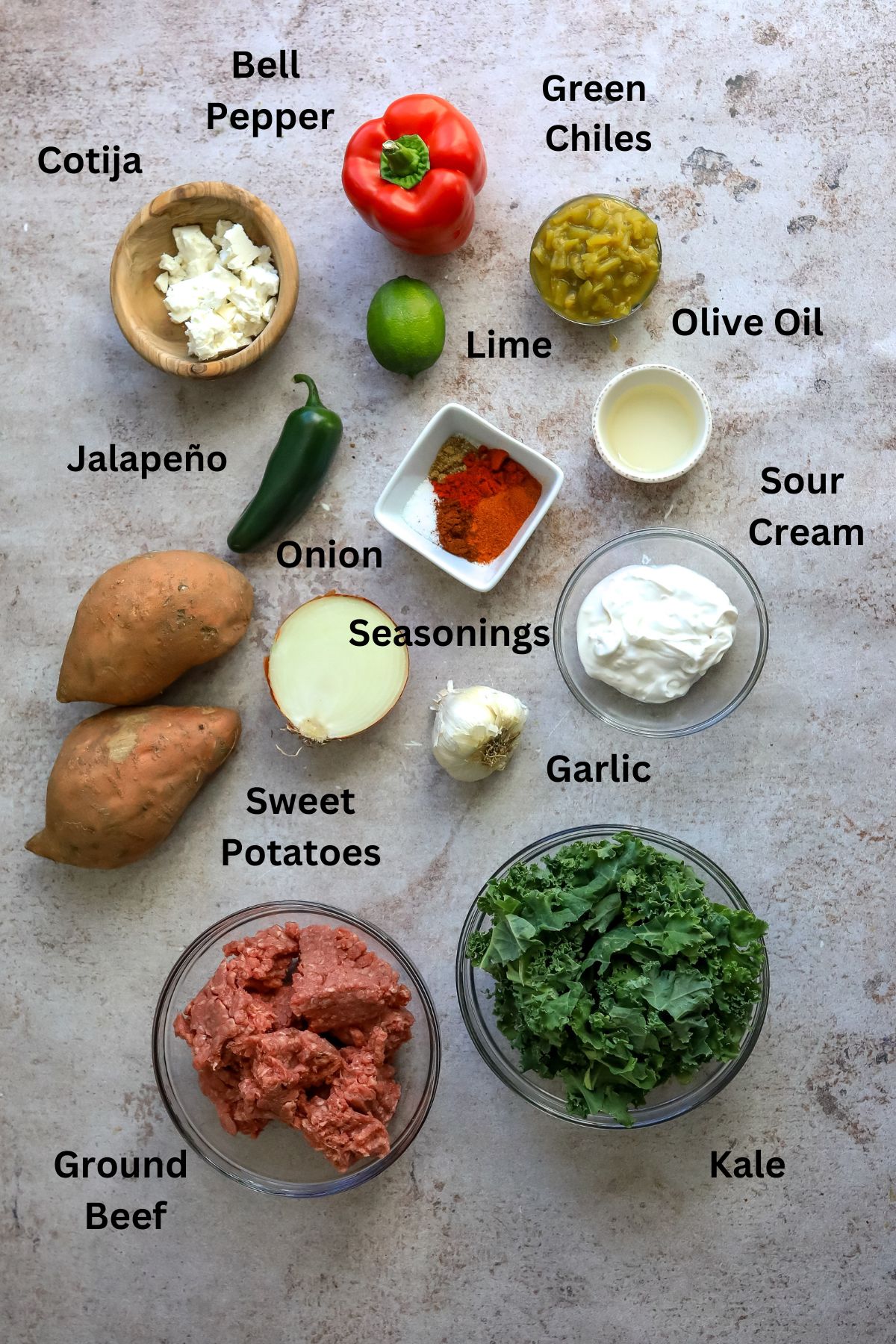 Ingredients laid out on a grey counter in small bowls and plates. 