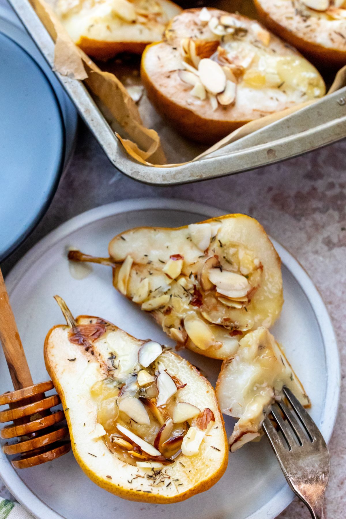 Baked Pears on a white plate with a fork and honey. 