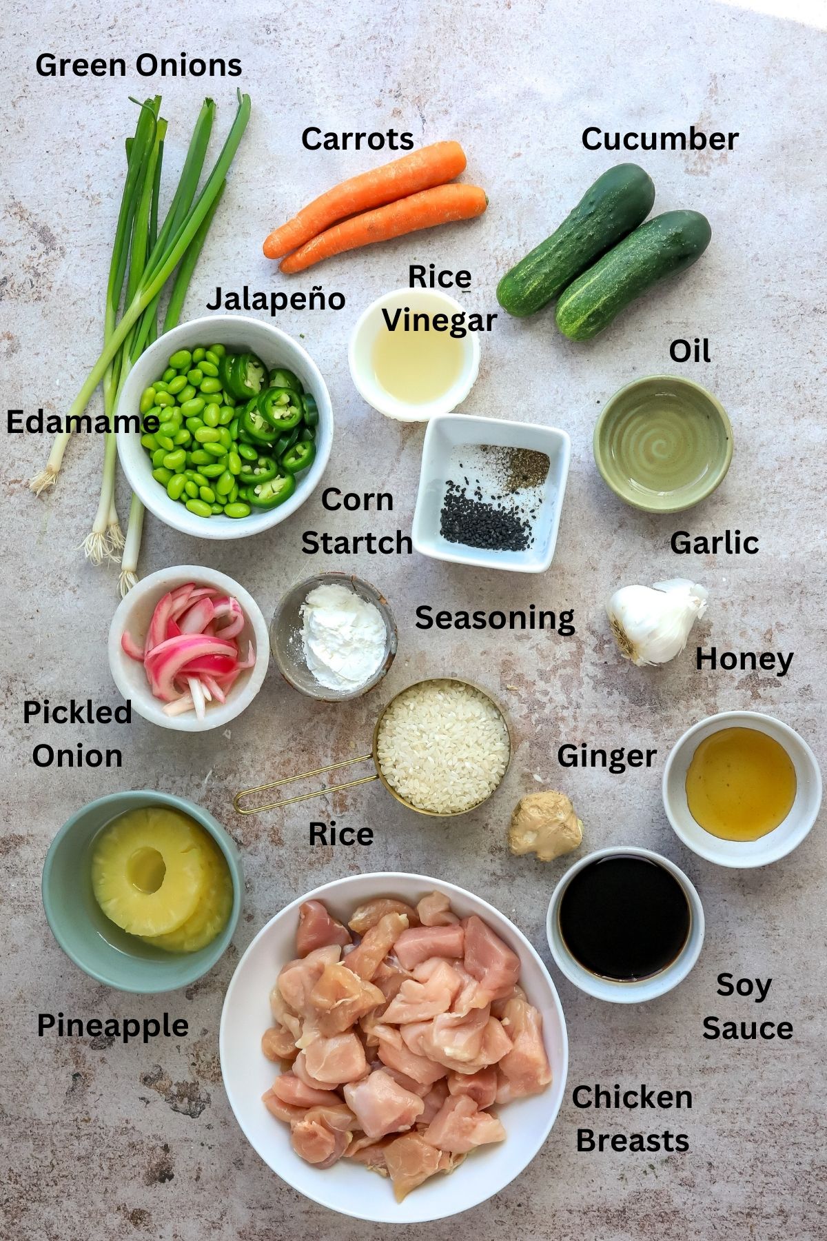 Ingredients needed to make chicken poke on a counter in small bowls and plates. 