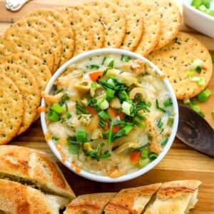 White ramekin filled with tuna and crackers on the side.