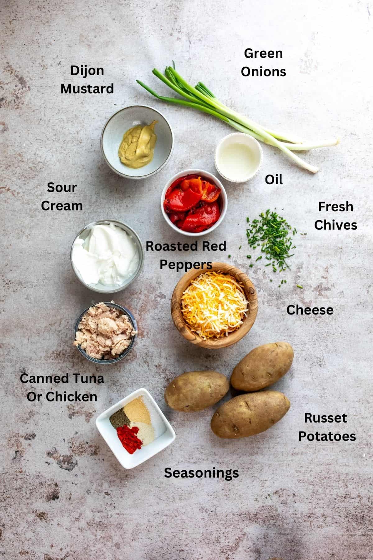 Ingredients needed to make tuna potatoes in small white bowls.