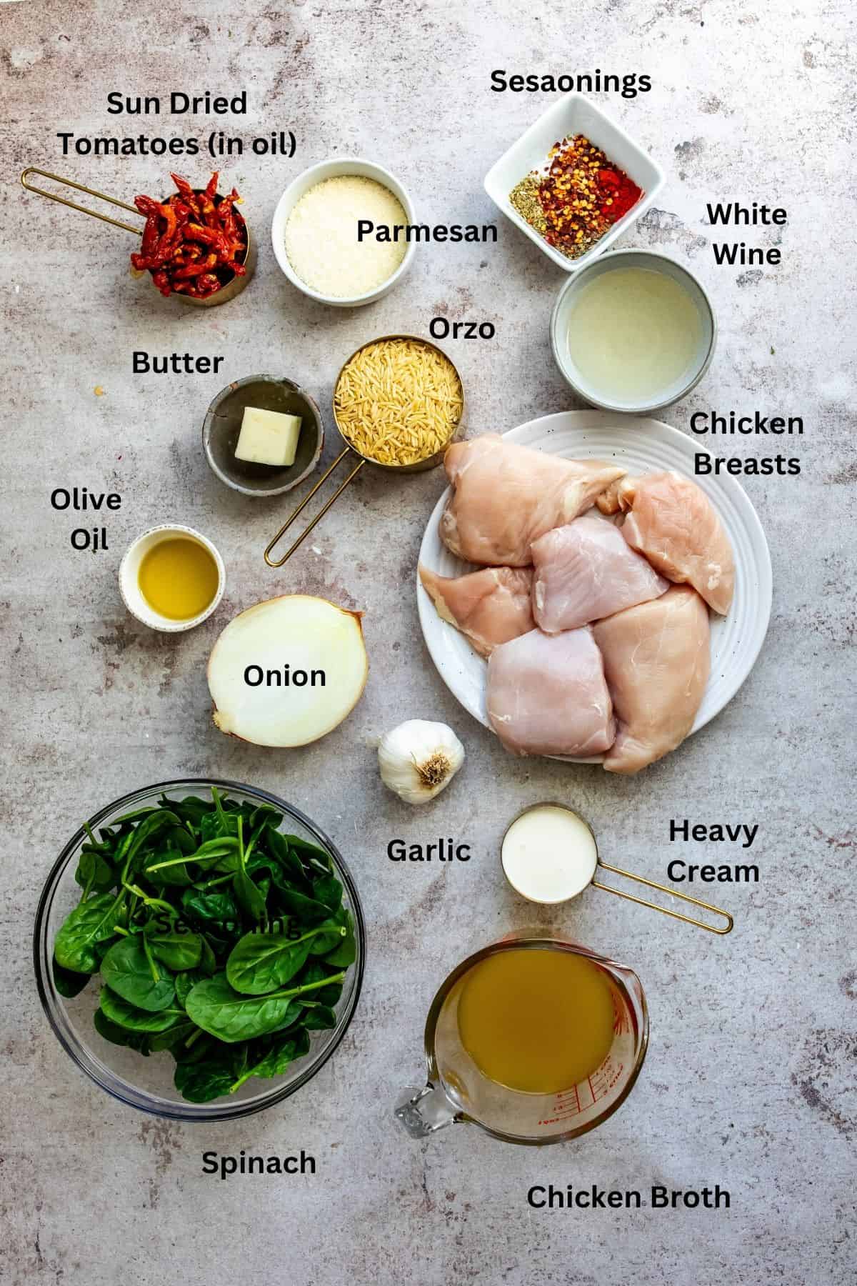 Chicken Orzo skillet ingredients on a counter in measuring cups and bowls. 