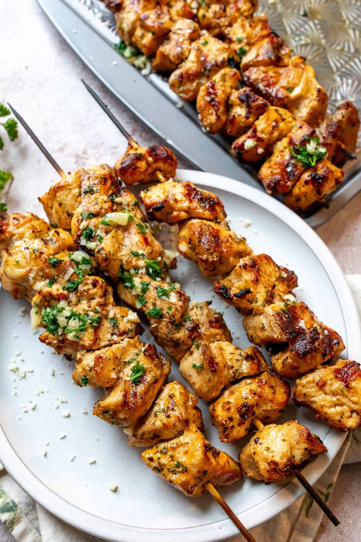 Chicken on a white plate. Baked chicken skewers. 