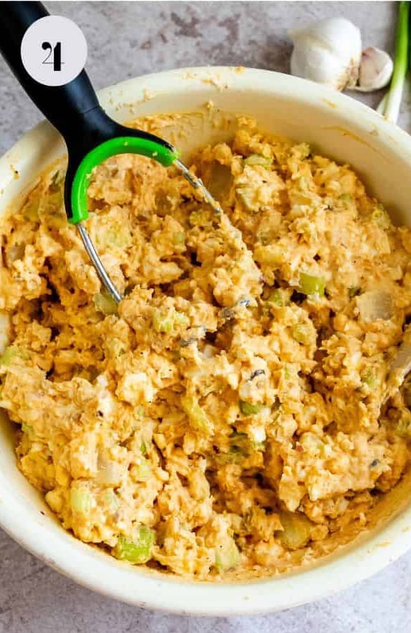 The mashed dressing ingredients in the bowl before finishing the potato salad.