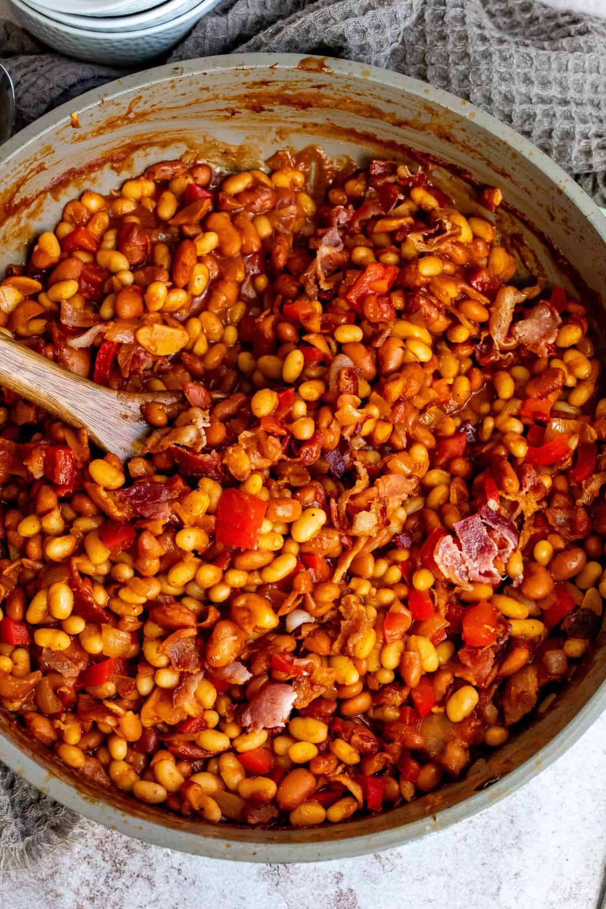 An overhead image of cooked baked beans, ready to be served.