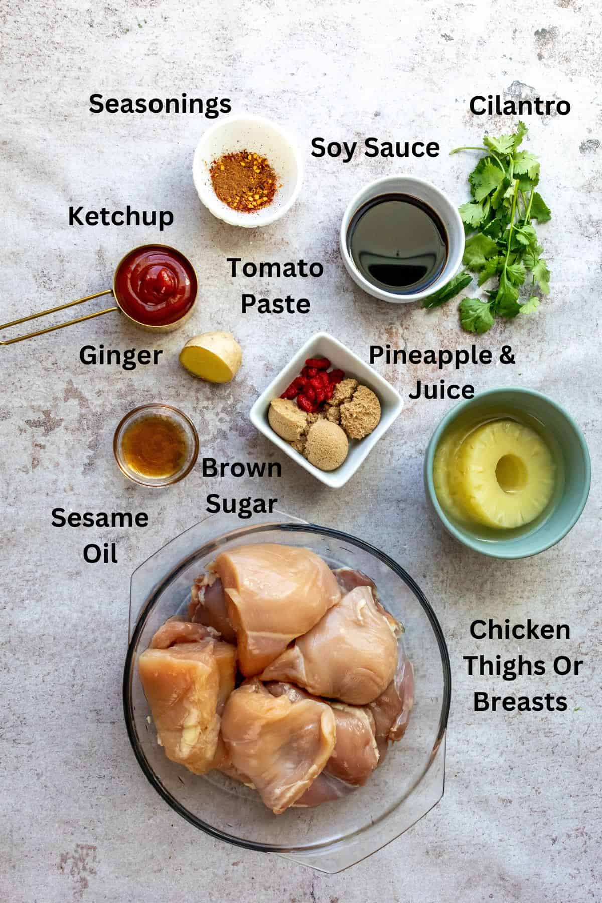 Ingredients in small bowls and measuring ups on a counter.