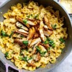 An overhead image of garlic parmesan chicken pasta in a skillet.
