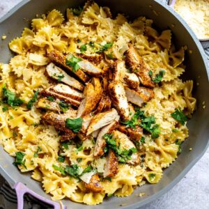 An overhead image of garlic parmesan chicken pasta in a skillet.