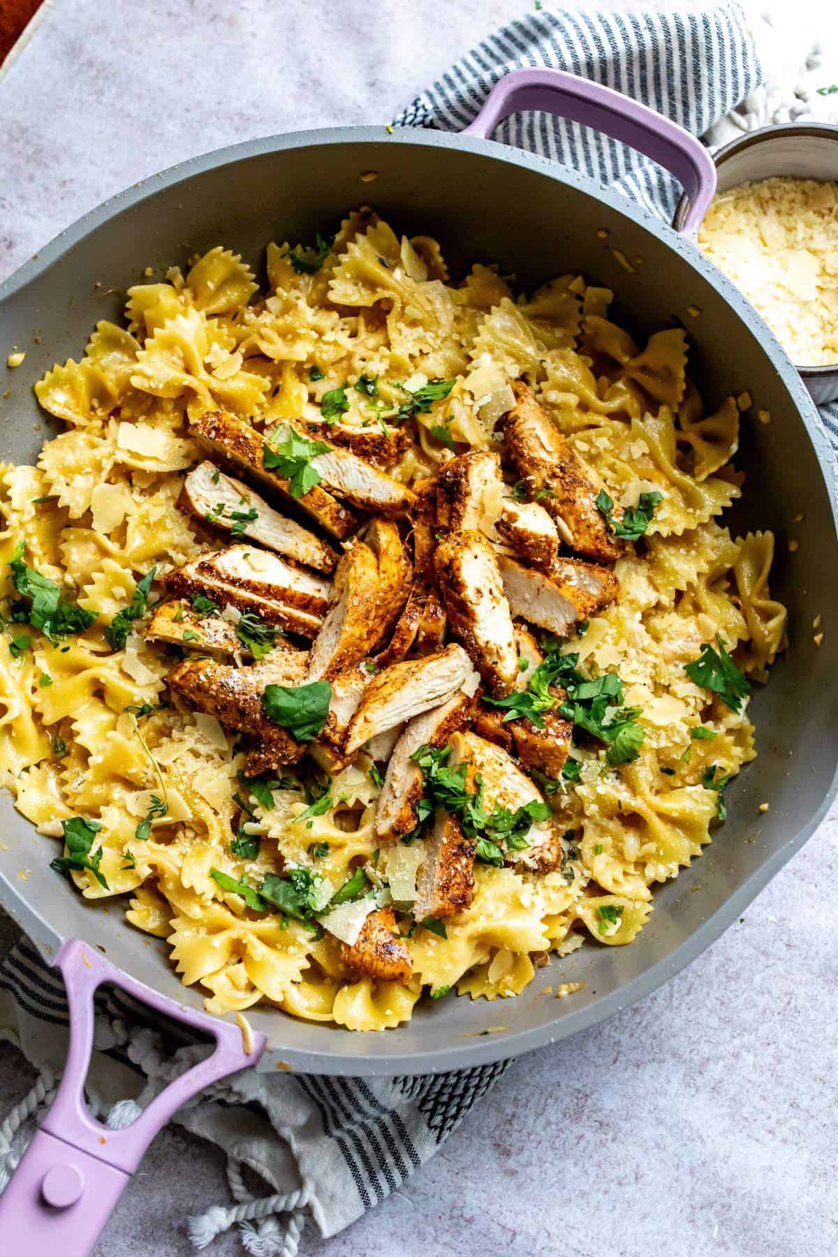 An overhead image of garlic parmesan chicken pasta in a skillet.