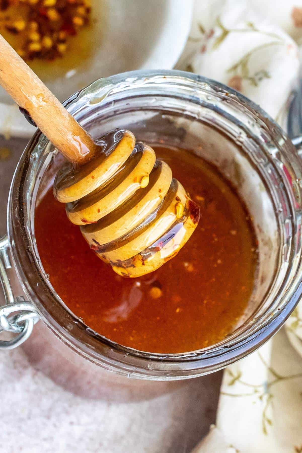 Up close photo of hot honey in a jar. 