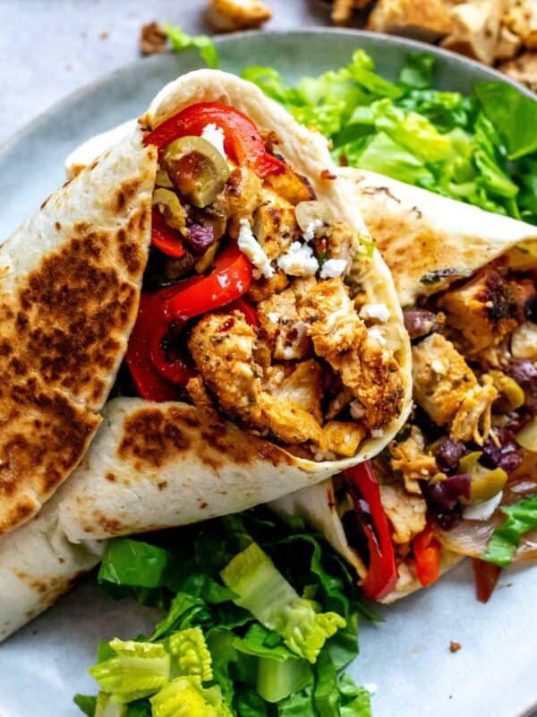 Mediterranean wraps on a plate with lettuce.