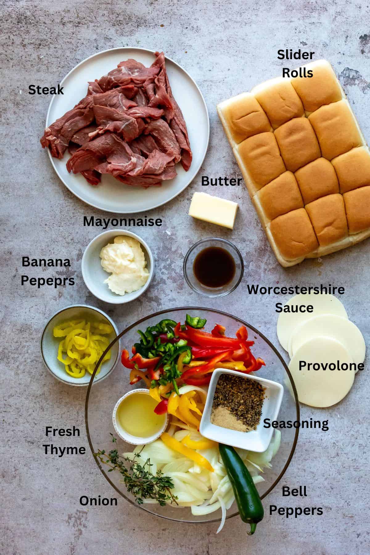 An image of the ingredients of philly cheesesteak sliders in separate containers.