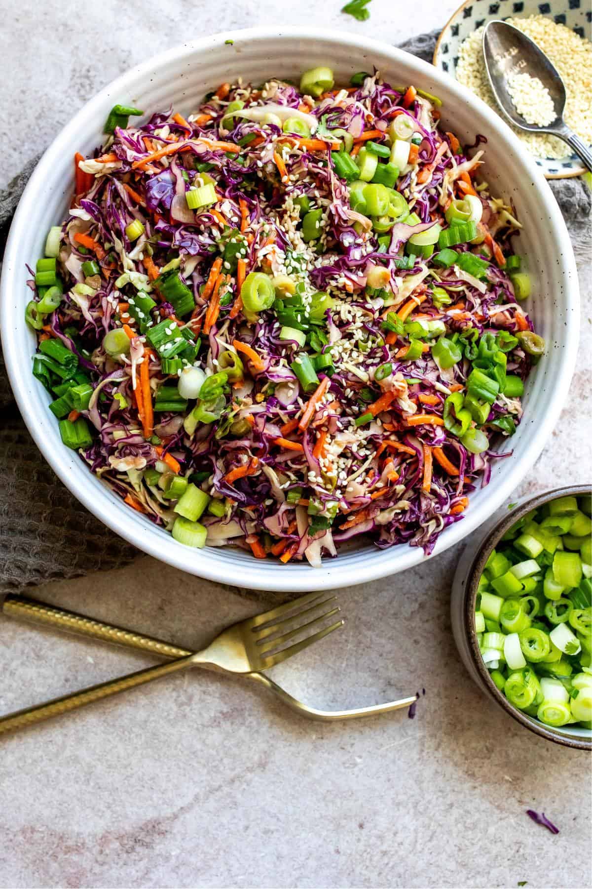 An overhead image of Asian coleslaw in a large serving bowl.