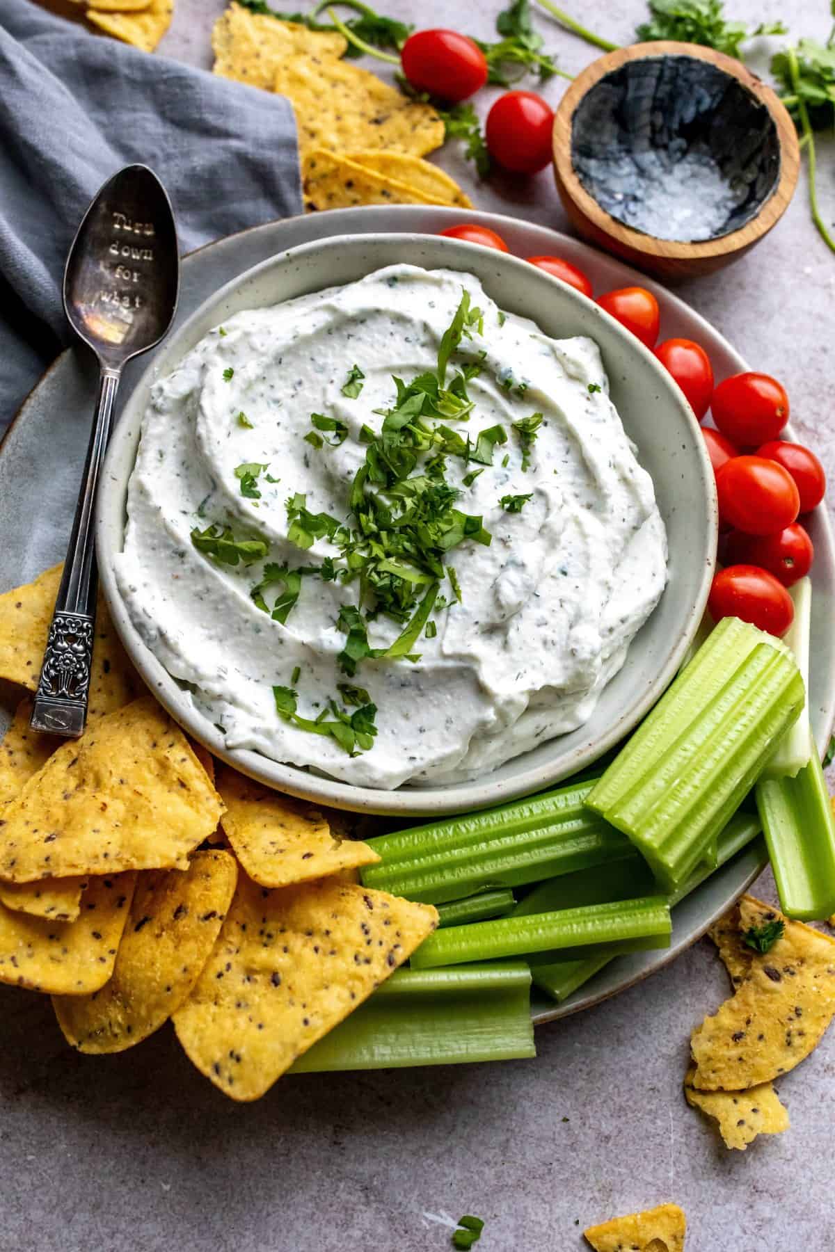 An overhead image of cottage cheese dip, with chips and veggies on the side for dipping.