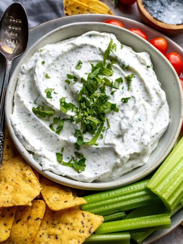 An overhead image of cottage cheese dip, with chips and veggies on the side for dipping.