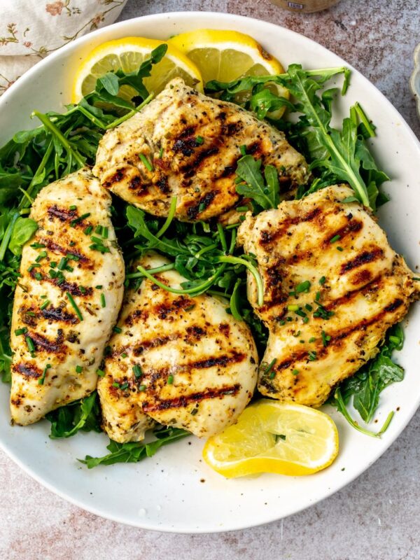 Herb Lemon Chicken on a plate with lemons.