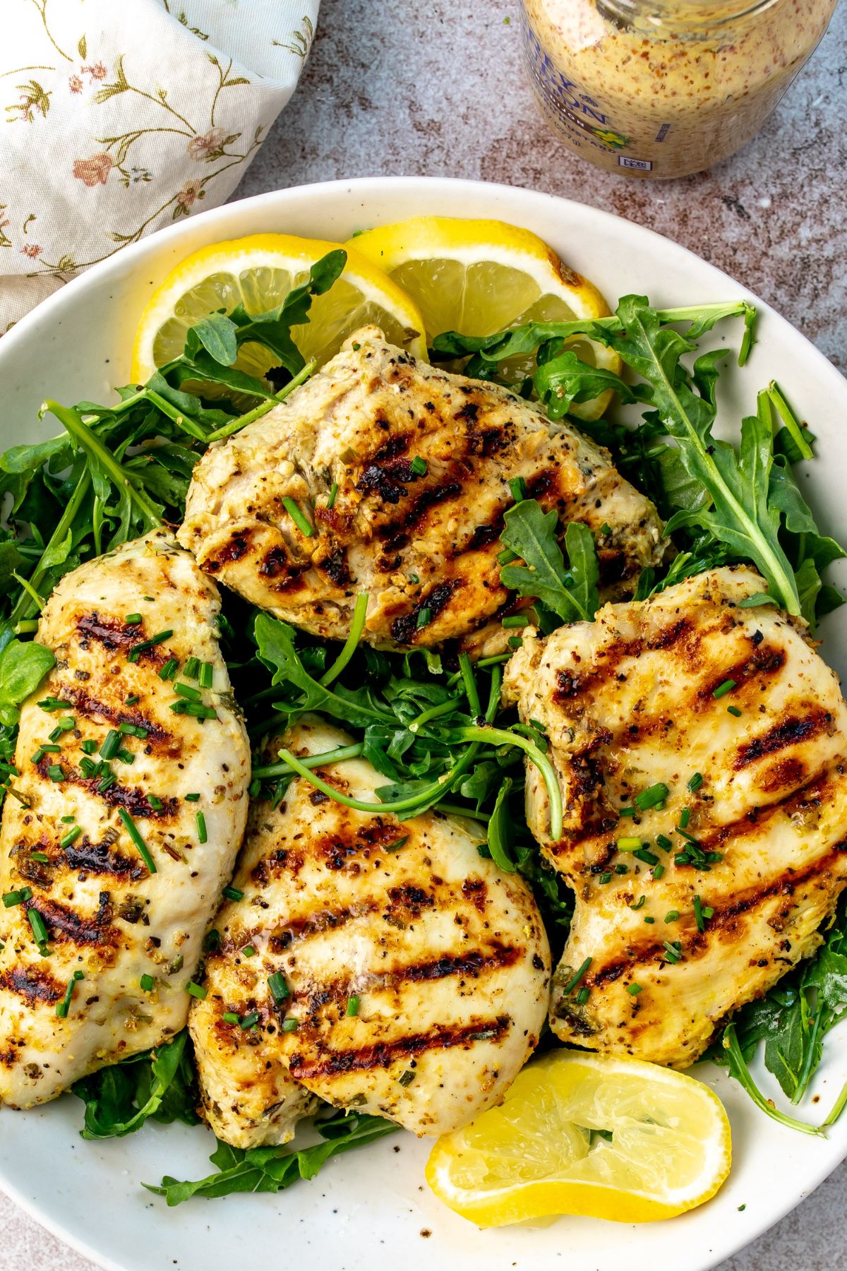 Herb Lemon Chicken on a plate with lemons.
