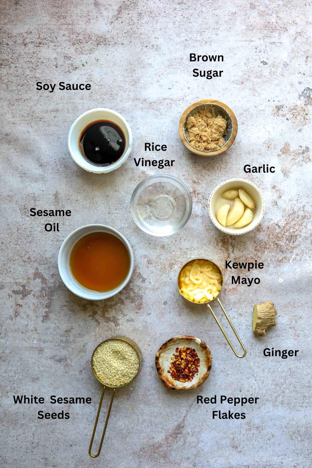 Small bowls and measuring cups with ingredients in them. 