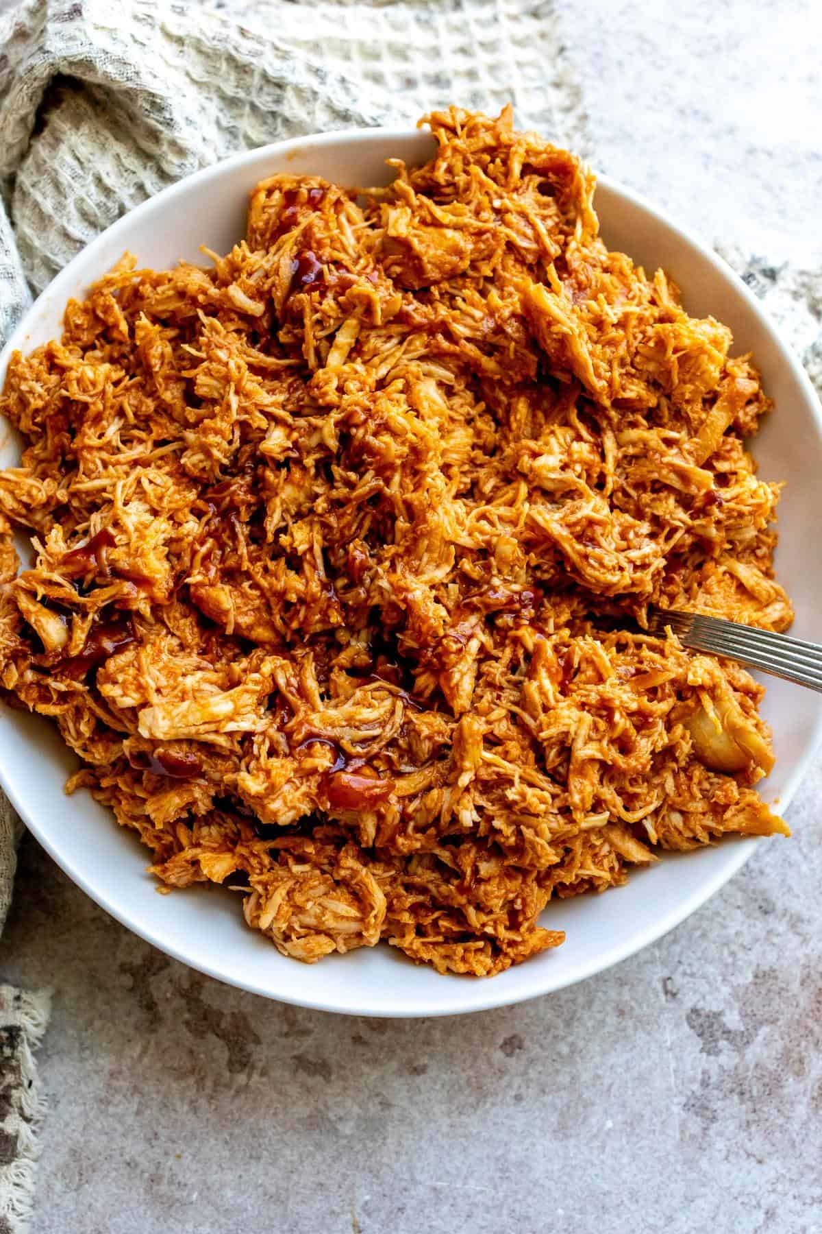 An image of shredded BBQ chicken in a serving plate.