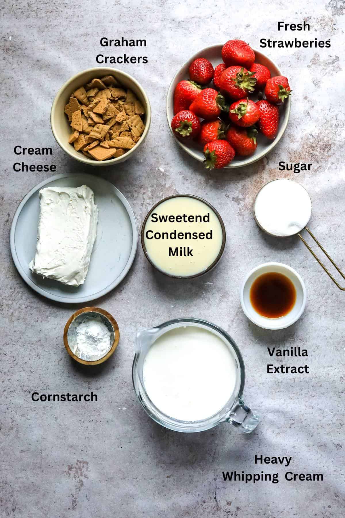 An overhead image of the ingredients of strawberry cheesecake ice cream.