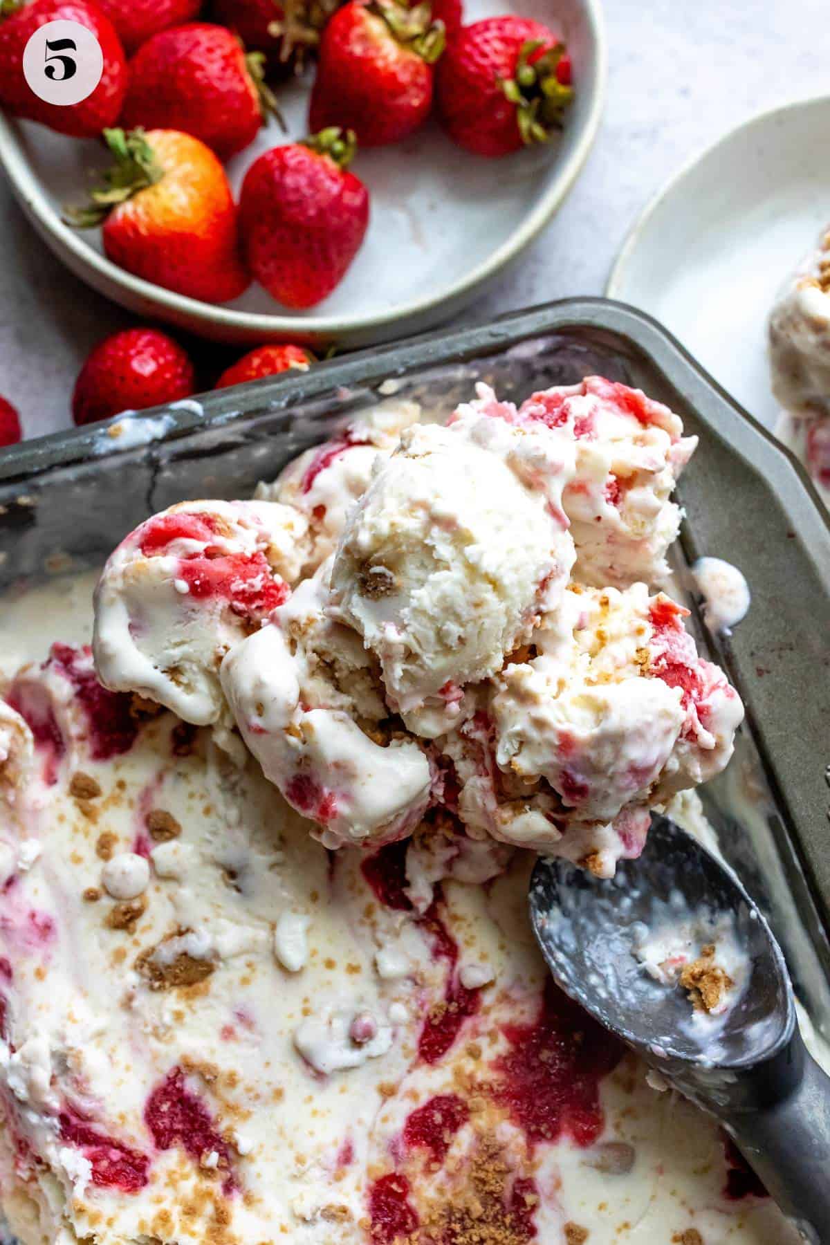 An image of scooping out ice cream from the baking dish.