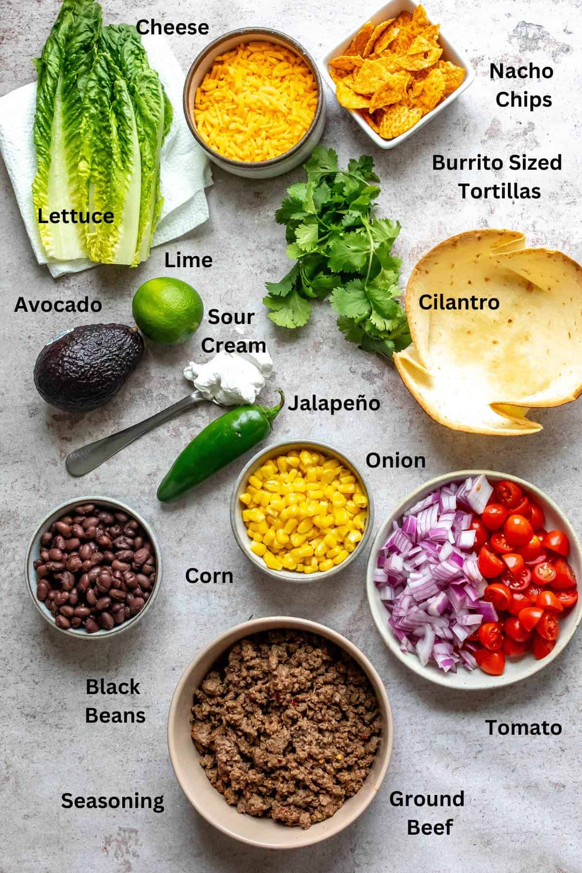 Ingredients needed to make the recipe on a counter in bowls and cups. 