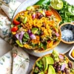 Taco Fiesta Salad on a grey plate with toppings and a tea towel on the side.