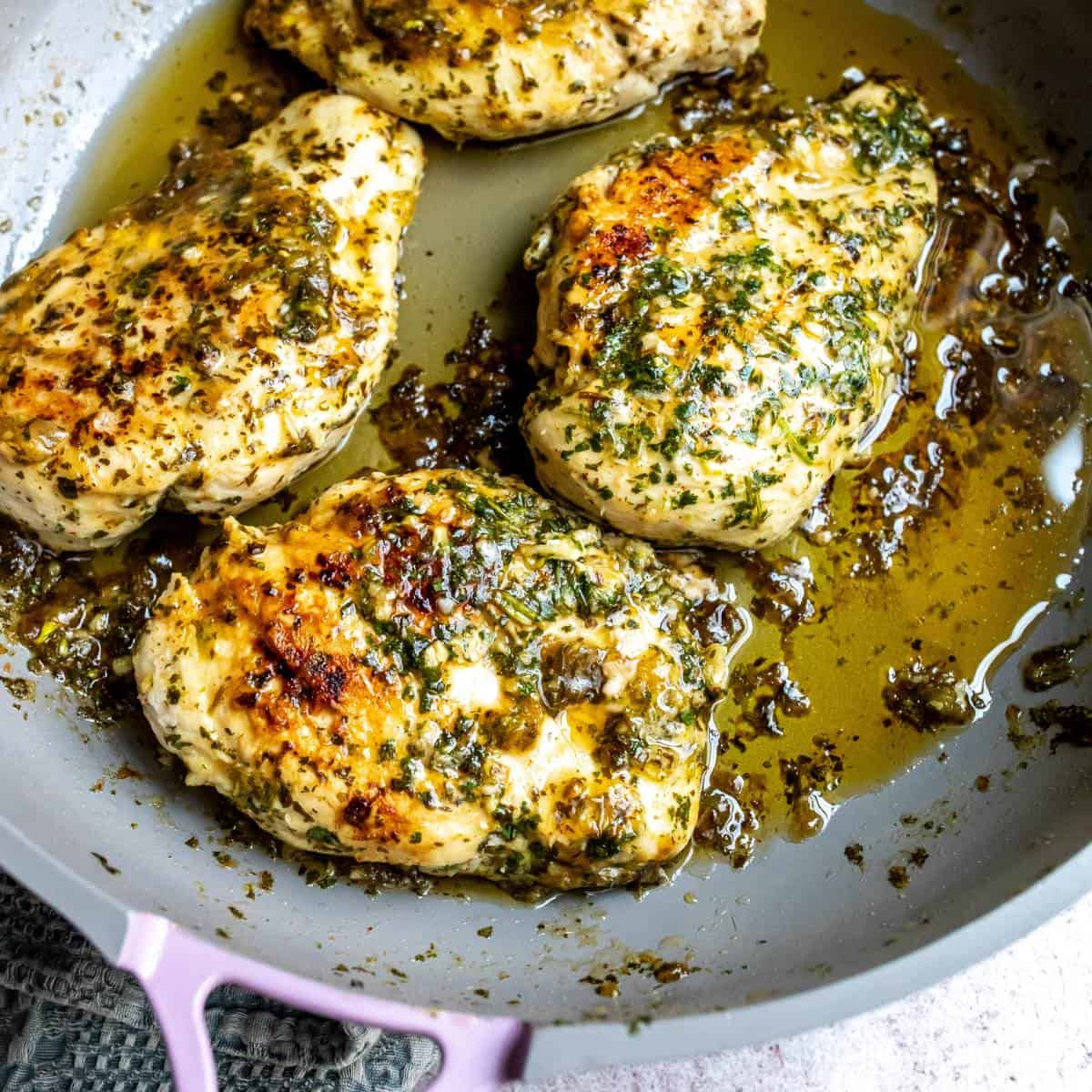 Grey skillet with Cilantro and Lime Chicken Marinade in it, Lime on the side.