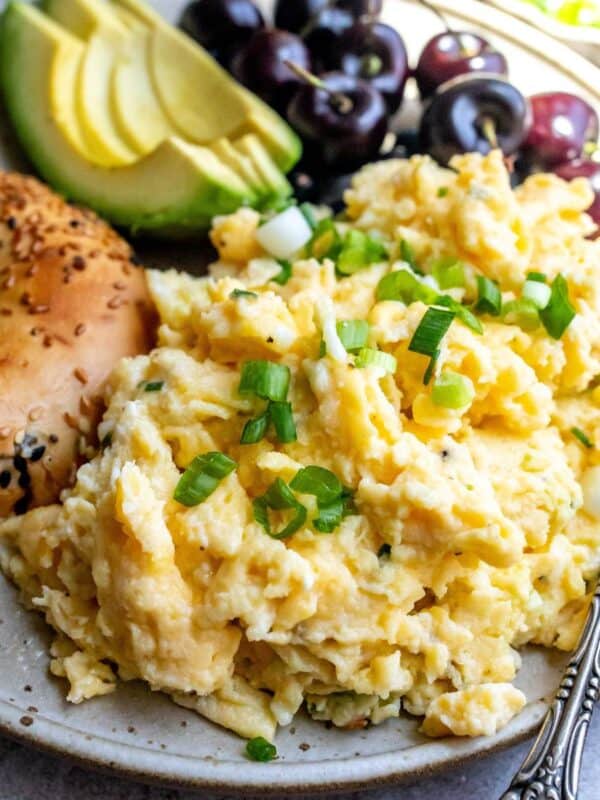 Cottage Cheese with Scrambled Eggs up close on a plate with a fork to the side.