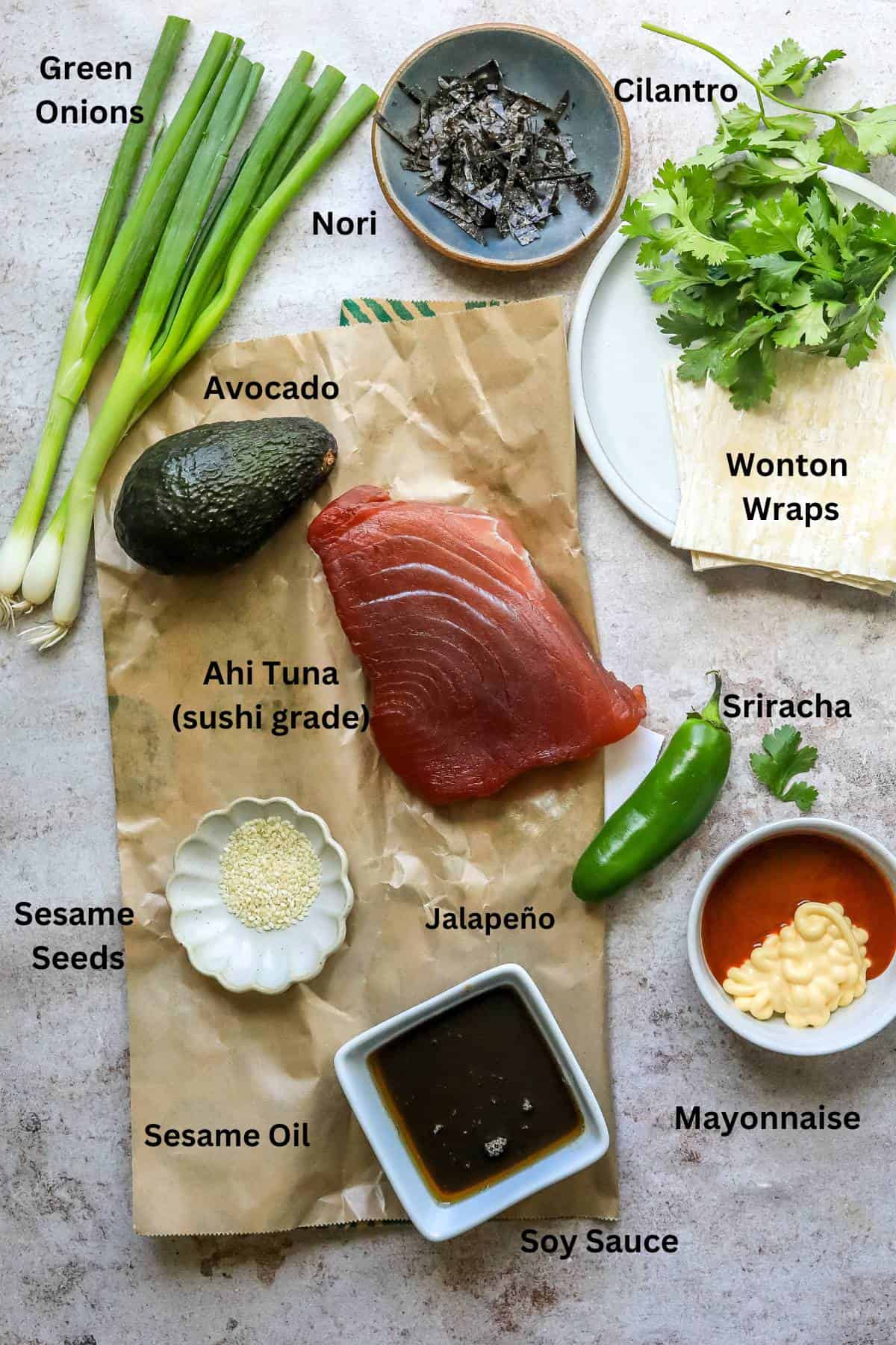 Ingredients to make Poke nachos in small bowls on a counter. 