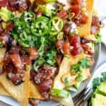 Poke Chip nachos on a plate with toppings.