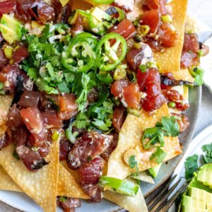 Poke Chip nachos on a plate with toppings.