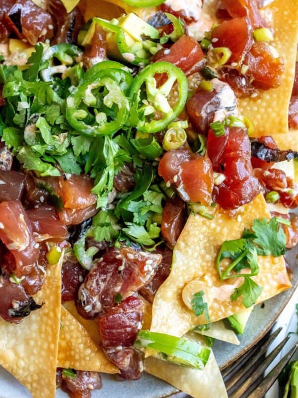 Poke Chip nachos on a plate with toppings.