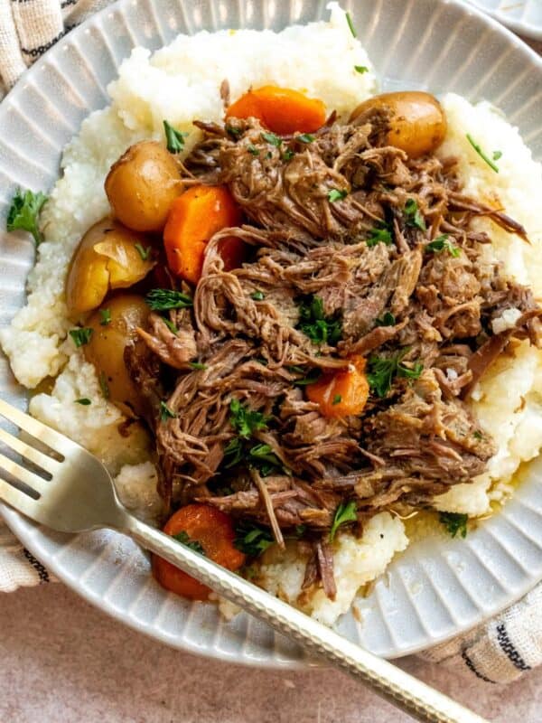 An overhead image beef chuck roast recipe with potatoes and carrots on a plate.