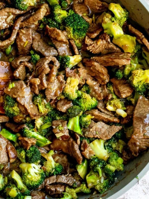 Over head photo of Beef and broccoli recipe in a pink skillet.