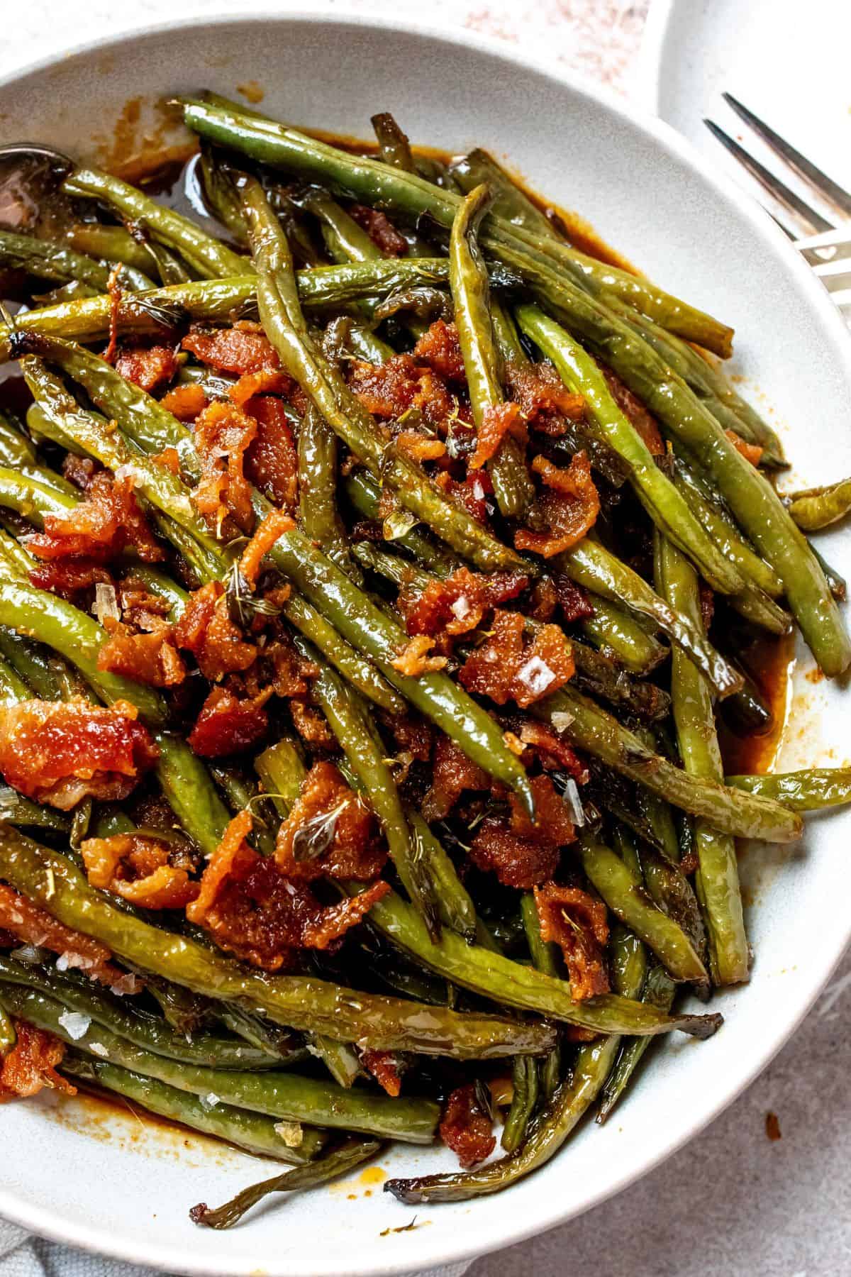 An close up image of green beans on a plate.