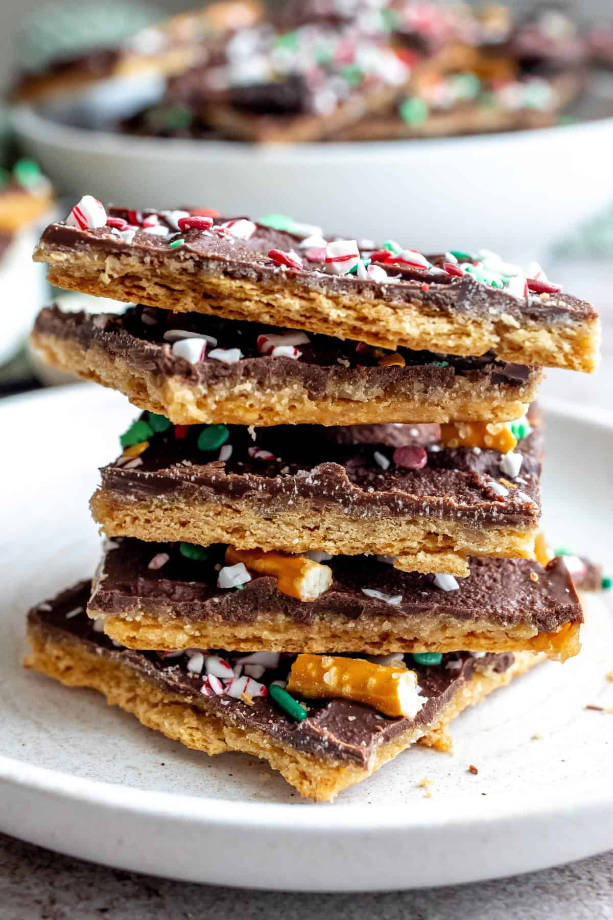 Up close photo of Christmas Bark stacked up on a plate. 