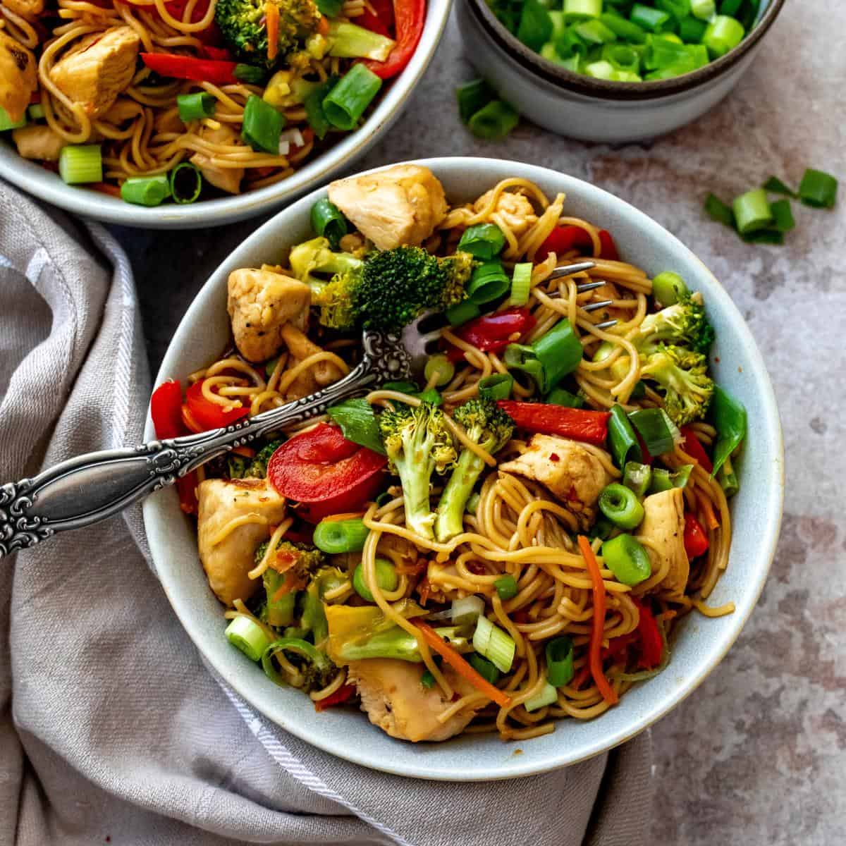 Teriyaki Chicken Ramen in a grey bowl with a dish towel on the side.