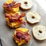 Freezer Breakfast Bagel Sandwiches on parchment paper.