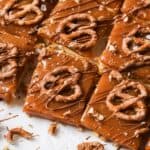 Caramel Cookie Bars on a counter with a drizzle of chocolate.