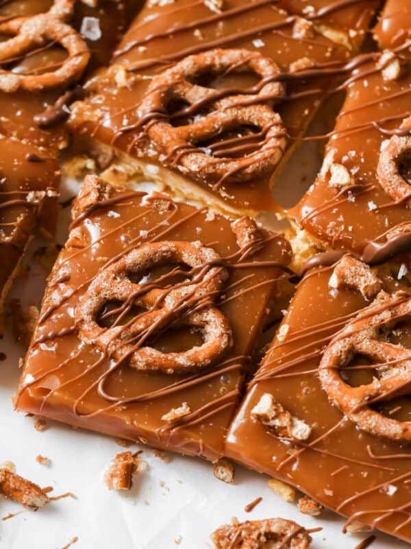 Caramel Cookie Bars on a counter with a drizzle of chocolate.