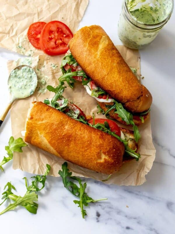 Green Goddess Caprese Melts on parchment paper with dressing to the side.