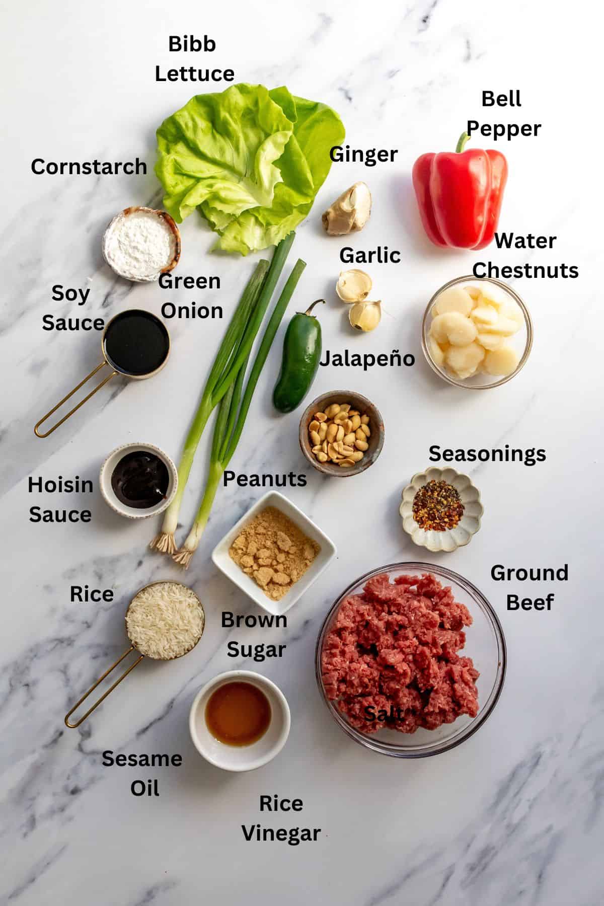 Ingredients needed to make the recipe on a white marble counter, in small bowls. 