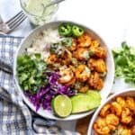 White ceramic bowl with Blackened Shrimp and toppings.