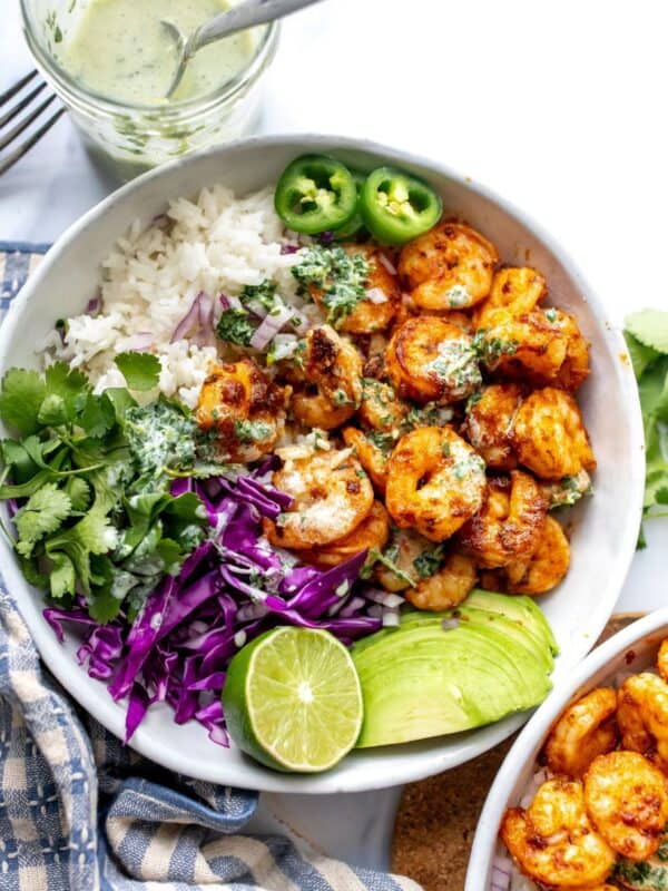 White ceramic bowl with Blackened Shrimp and toppings.